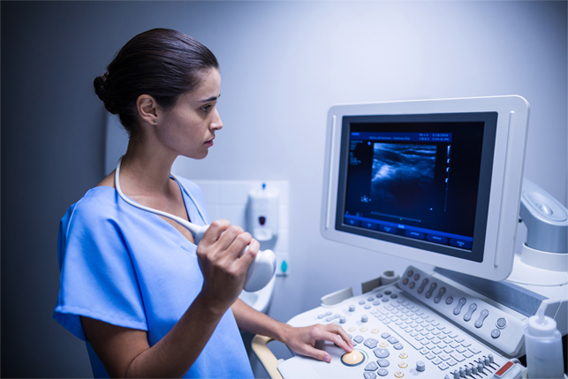Nurse using ultrasonic device in hospital