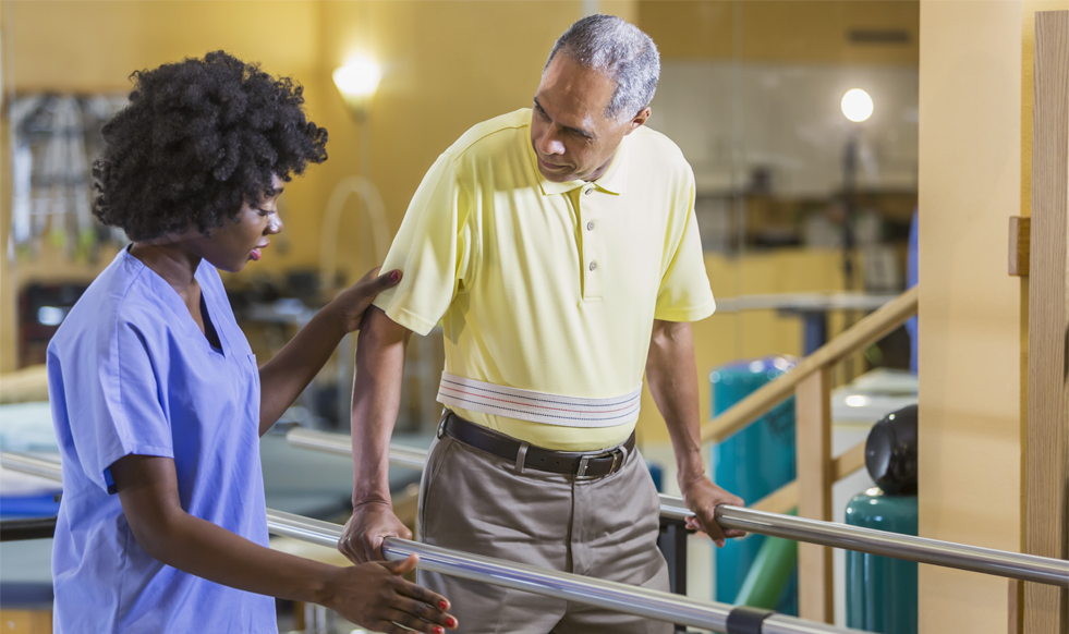 Female physical therapist working with male patient